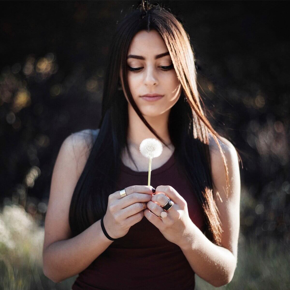 woman holding dandelion flower